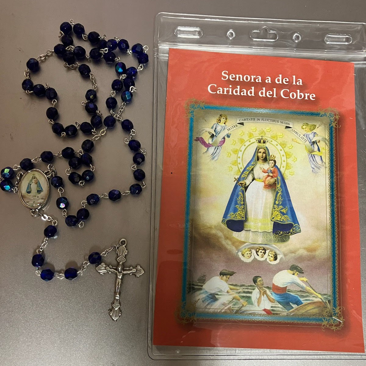 Caridad del Cobre, Dark Blue Bead Rosary with Image Center and Spanish Holy Card